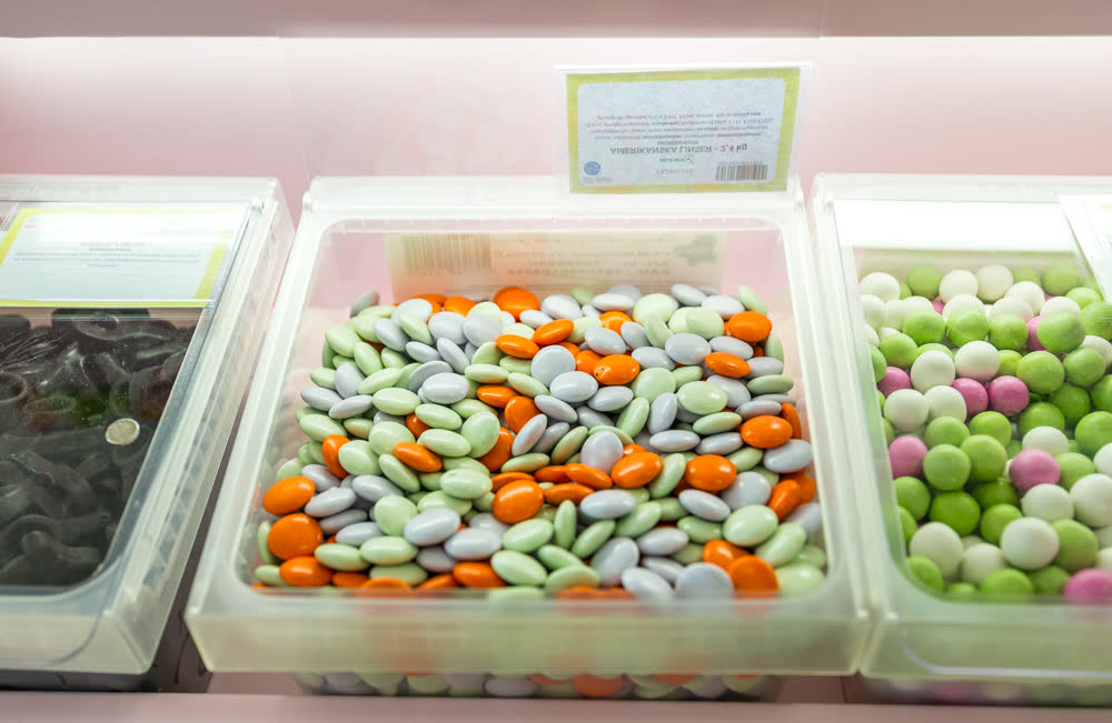 A tub of colorful chocolate lentil sweets