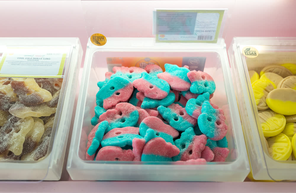 A tub of pink and teal sugared sweets